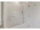 Bright bathroom featuring a white subway tiled tub with a shower and a built-in niche at 3513 Bellevue Rd, Raleigh, NC 27609