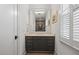 Elegant bathroom vanity with marble countertop, dark cabinets and a large mirror at 3513 Bellevue Rd, Raleigh, NC 27609