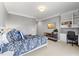 Well-lit bedroom featuring a desk, shelving, and soft carpet at 3513 Bellevue Rd, Raleigh, NC 27609
