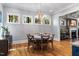 Bright dining area with hardwood floors, decorative light fixture, and views of the backyard at 3513 Bellevue Rd, Raleigh, NC 27609