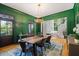 Formal dining room with green accent wall, hardwood floors, and stylish chandelier at 3513 Bellevue Rd, Raleigh, NC 27609