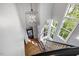 Bright foyer with chandelier, hardwood floors and staircase with black railings at 3513 Bellevue Rd, Raleigh, NC 27609