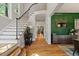 Spacious foyer featuring a staircase, hardwood floors, and elegant decor at 3513 Bellevue Rd, Raleigh, NC 27609