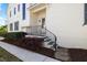 Inviting front porch with black metal railing and stone steps leads to a beautifully landscaped yard at 3513 Bellevue Rd, Raleigh, NC 27609