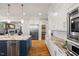 Beautiful kitchen with large island, marble countertops, stainless appliances, and white cabinetry at 3513 Bellevue Rd, Raleigh, NC 27609