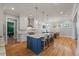 Spacious kitchen with a large island and breakfast bar seating flowing into the eat-in kitchen at 3513 Bellevue Rd, Raleigh, NC 27609