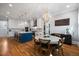 Open kitchen and dining area featuring an eat-in island, white cabinets and stainless steel appliances at 3513 Bellevue Rd, Raleigh, NC 27609