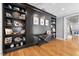 Living room features beautiful hardwood floors and built-in dark shelving with custom decor at 3513 Bellevue Rd, Raleigh, NC 27609