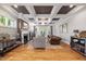 Cozy living room with a fireplace, coffered ceiling, hardwood floors, and French doors to the backyard at 3513 Bellevue Rd, Raleigh, NC 27609