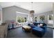 Spacious living room featuring vaulted ceilings, a large window, and a comfortable blue sofa at 3513 Bellevue Rd, Raleigh, NC 27609