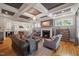 Spacious living room featuring fireplace, hardwood floors, stylish furnishings, and a coffered ceiling at 3513 Bellevue Rd, Raleigh, NC 27609