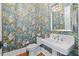 Stylish powder room featuring vibrant monkey wallpaper and a classic pedestal sink at 3513 Bellevue Rd, Raleigh, NC 27609