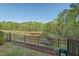 View of the backyard featuring trees, a pond, and a fence at 36 Argonaut Dr, Durham, NC 27705