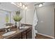 Bathroom with dual sinks, granite countertops, decorative accents, and a bright window for natural light at 36 Argonaut Dr, Durham, NC 27705