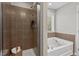 Bathroom showcasing a shower with tiled walls adjacent to a soaking tub next to a window for natural light at 36 Argonaut Dr, Durham, NC 27705