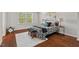 Bright bedroom with hardwood floors, a large window, and stylish furnishings, including a patterned bed and bench at 36 Argonaut Dr, Durham, NC 27705