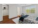 Bedroom featuring hardwood floors, a window with natural light, and a glimpse of a walk-in closet at 36 Argonaut Dr, Durham, NC 27705