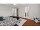 Bedroom showcasing hardwood floors, a comfortable bed, and doors leading to the closet and bathroom at 36 Argonaut Dr, Durham, NC 27705