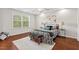 Bright bedroom with hardwood floors, a large window, and stylish furnishings, including a patterned bed and bench at 36 Argonaut Dr, Durham, NC 27705