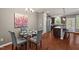 Dining area next to kitchen, features a modern chandelier and seating for four at 36 Argonaut Dr, Durham, NC 27705