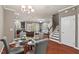 Open-concept dining area with a modern glass table, stylish chairs, and staircase access at 36 Argonaut Dr, Durham, NC 27705