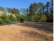 Dog park with wood chip ground cover, perimeter fence, and dog tunnel at 36 Argonaut Dr, Durham, NC 27705