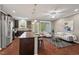 Open-concept kitchen flowing into a living area, with an island and stainless steel appliances at 36 Argonaut Dr, Durham, NC 27705