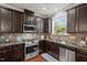Well-equipped kitchen featuring stainless steel appliances, granite countertops, and modern backsplash at 36 Argonaut Dr, Durham, NC 27705