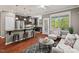 Sunlit living area and kitchen with stainless steel appliances and an island with barstool seating at 36 Argonaut Dr, Durham, NC 27705