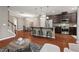 Open-concept kitchen and living area with stairs, modern appliances, and a dining area at 36 Argonaut Dr, Durham, NC 27705