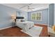 Cozy main bedroom with hardwood floors, a ceiling fan, and natural light from a window at 36 Argonaut Dr, Durham, NC 27705