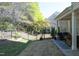 Large backyard featuring a well-manicured lawn, mature trees, and a patio with outdoor furniture at 409 Courthouse Dr, Morrisville, NC 27560