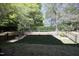 Well-maintained backyard with a metal fence, mature trees, and a healthy green lawn at 409 Courthouse Dr, Morrisville, NC 27560