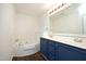 Bathroom featuring a soaking tub, double vanity, and modern fixtures at 409 Courthouse Dr, Morrisville, NC 27560