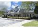 Exterior view of the clubhouse, featuring well-manicured landscaping and ample parking at 409 Courthouse Dr, Morrisville, NC 27560