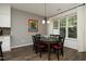 Dining room features hardwood floors, a modern light fixture, and a large window at 409 Courthouse Dr, Morrisville, NC 27560