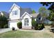 Beautiful two-story home featuring stone accents, a manicured lawn, and an attached two car garage at 409 Courthouse Dr, Morrisville, NC 27560