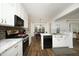 Bright, modern kitchen with stainless steel appliances, breakfast bar, and adjacent dining area at 409 Courthouse Dr, Morrisville, NC 27560