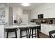 Well-lit kitchen with stainless steel appliances, granite countertops, and a breakfast bar with seating at 409 Courthouse Dr, Morrisville, NC 27560