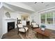 Open-concept living room with hardwood floors, a fireplace, and views into the kitchen at 409 Courthouse Dr, Morrisville, NC 27560