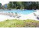 Community pool with lounge chairs and tables for residents to relax and enjoy the summer at 409 Courthouse Dr, Morrisville, NC 27560