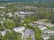 Panoramic aerial view showcasing a community surrounded by lush greenery and roadways at 4210 Brynwood Ave, Durham, NC 27713