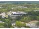 Modern school building nestled among lush greenery with well-maintained grounds and ample parking at 4210 Brynwood Ave, Durham, NC 27713