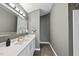Modern bathroom with white vanity, silver fixtures, and wood-look flooring at 4210 Brynwood Ave, Durham, NC 27713