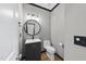 Modern powder room featuring a vanity, round mirror, and sleek fixtures at 4210 Brynwood Ave, Durham, NC 27713