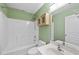 Bathroom showcasing neutral colors, a shower, cabinet, toilet, and sink at 4210 Brynwood Ave, Durham, NC 27713