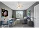 Bedroom featuring neutral colors, a ceiling fan, and a cozy bed under natural light at 4210 Brynwood Ave, Durham, NC 27713