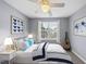 Beautifully staged bedroom with blue accents, a guitar and natural light at 4210 Brynwood Ave, Durham, NC 27713