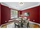 Cozy dining room with burgundy walls, crown molding, and wood table at 4210 Brynwood Ave, Durham, NC 27713