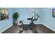 Bright exercise room with a modern exercise bike, plant, and decor at 4210 Brynwood Ave, Durham, NC 27713